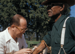 Tuskegee Syphilis Study. Image shows a White doctor treating a Black man.